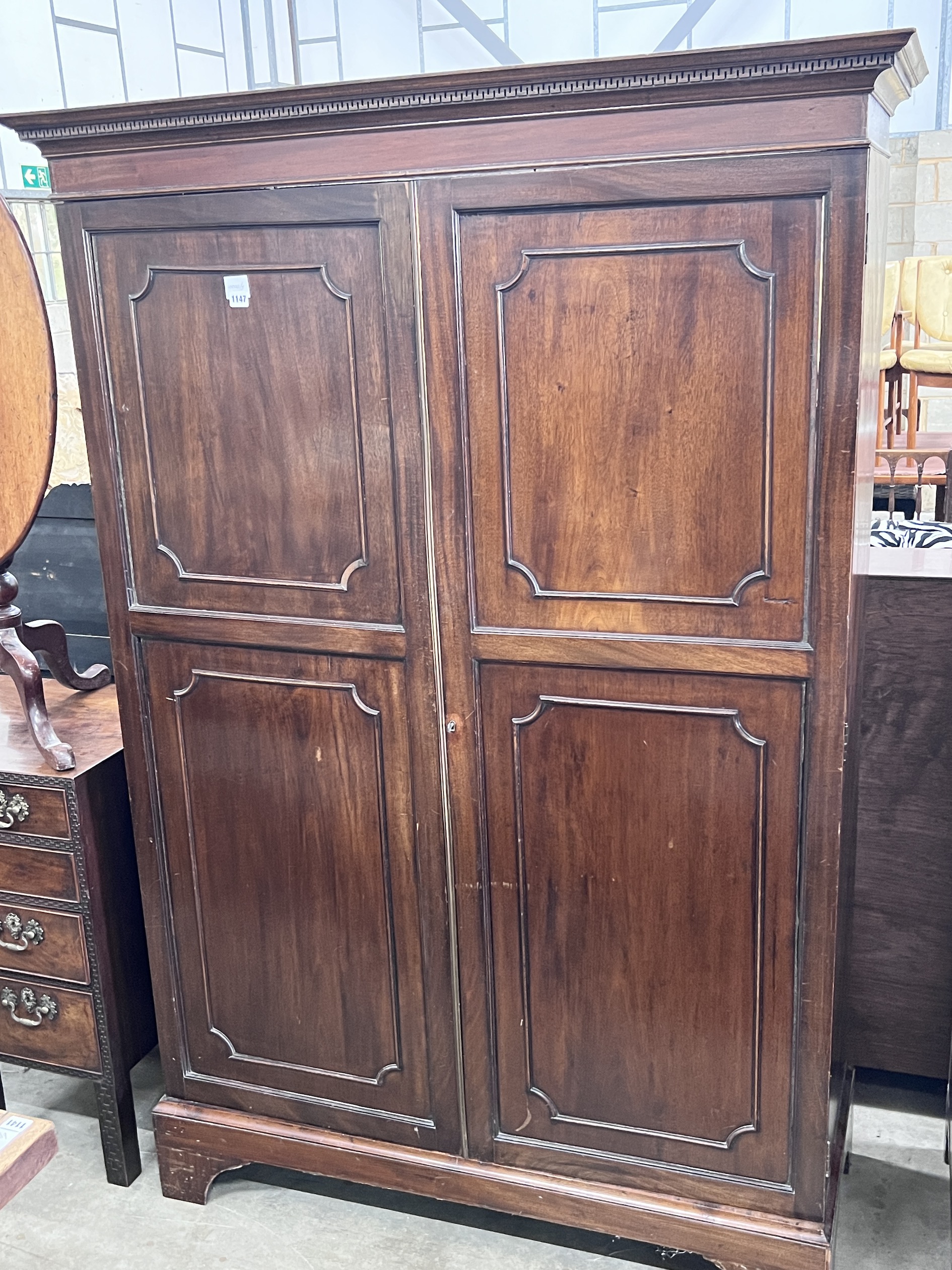 An Edwardian George III style mahogany two door wardrobe, width 132cm, depth 50cm, height 195cm